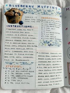 an open book with blueberry muffins and instructions on the inside, sitting on a white blanket