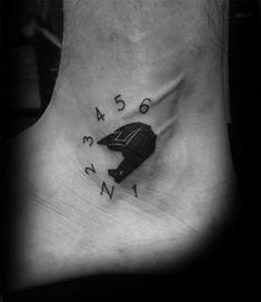 a black and white photo of a person's foot with a bird on it