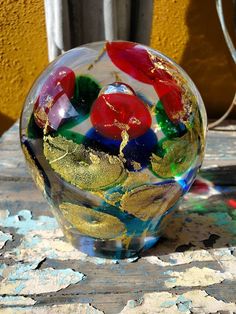 a glass vase sitting on top of a wooden table