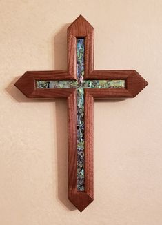 a wooden cross mounted to the side of a wall