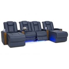 a row of blue leather reclining chairs with lights on the side and back seats facing each other