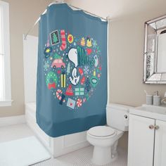 a bathroom with a blue shower curtain and white toilet