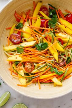 a white bowl filled with sliced vegetables and garnished with cilantros