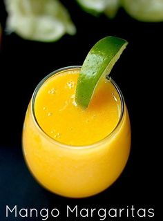 an orange smoothie with a green leaf sticking out of it