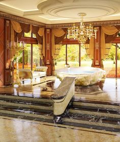 a fancy bathroom with chandelier, tub and marble steps leading up to it