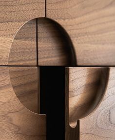 a close up of a wooden object with holes in the center and an opening at the end