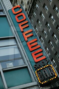 a large sign on the side of a building that says coffee for bar and grill