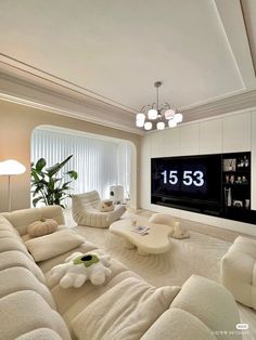 a living room filled with furniture and a large flat screen tv mounted to the wall