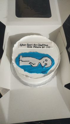 a cake in a white box with blue icing on the inside and writing on the outside