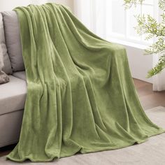 a couch with a green blanket on top of it