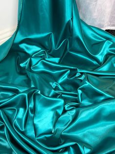 "TEAL ACETATE SATIN FABRIC Product information 1 mtr teal quality acetate satin fabric 45\" wide 114cm Ideal for decorations,dress making,bridal,dresses,dress lining,waistcoats,jackets,table runners,crafts, and many other projects Sold by the mtr If more than one quantity is bought it will be sent as one continous length" Drape Fabric, Dress Drape, Elegant Fabric, Net Fabric, Stunning Gowns, Dress Satin, Leopard Print Dress, Gold Shimmer, Draped Fabric