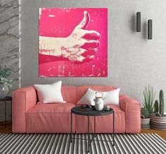 a living room with a pink couch and white pillows