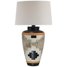 a table lamp with a black base and white lampshade on the bottom side