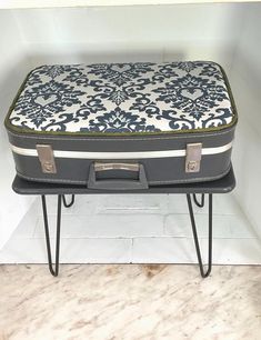 a suitcase sitting on top of a stool