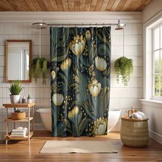 a bathroom with a shower curtain that has flowers on it and plants in the background