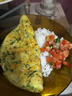 an omelet and rice dish on a plate with a side of tomato salsa