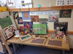 a wooden table topped with lots of art and crafting supplies on top of it