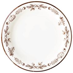 a white plate with brown trim and leaves on it