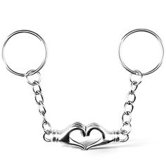 two heart shaped keys attached to each other on a keychain that is made out of metal