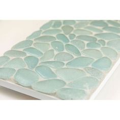 a white book with blue pebbles on it