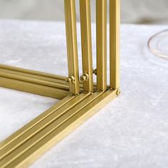 three golden metal frames sitting on top of a white table