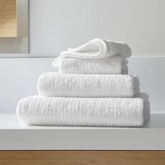 a stack of white towels sitting on top of a counter