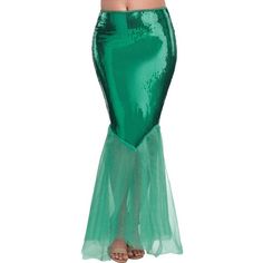 a woman in a green mermaid costume with her hands on her hips and arms behind her back