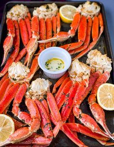 there is a platter full of lobsters and lemon wedges