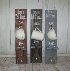 three wine glasses are lined up in front of two wooden signs that say how to tell time