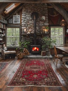 a room with wood floors, stone walls and a fire place in the middle of it