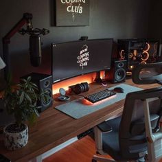 a desk with a computer and speakers on it