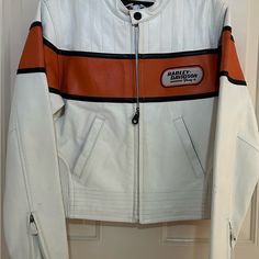 Women’s Harley Davidson Leather Jacket Size Small. Heavy Weight Leather. Beautiful Sporty Jacket. Never Worn. Orange Color Polyester Inner Lining. Two Zipper Hand Warming Pockets, Zipper Sleeve Ends, Snap-Down Collar, Two Inside Pockets, Elastic Sides. Casual White Leather Winter Jacket, Casual White Leather Jacket For Winter, Classic White Leather Jacket With Long Sleeves, White Fitted Leather Outerwear, Fitted White Leather Outerwear, Classic White Long Sleeve Leather Jacket, Casual White Biker Jacket For Fall, White Leather Long Sleeve Outerwear, Classic Fitted White Leather Jacket