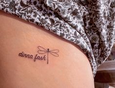 a woman with a tattoo on her stomach that says, dana fish in cursive writing