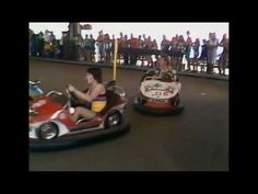 two people riding bumper cars in an amusement park