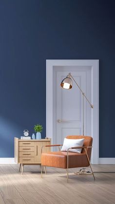 an orange chair in front of a blue wall with a white door and floor lamp