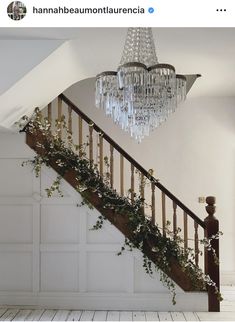 a chandelier hanging from the side of a stair case