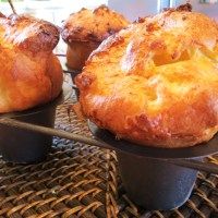 several muffins sitting on top of black pans