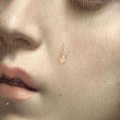 a close up of a woman's face with tears on her eyes and nose