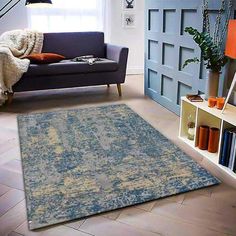 a living room filled with furniture and a blue rug