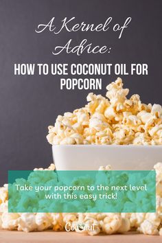 a white bowl filled with popcorn sitting on top of a wooden table