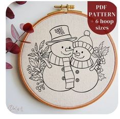 a cross - stitch pattern with a snowman and a dog in a top hat