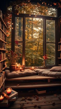 a bedroom with a window, bookshelf and candles on the floor in front of it