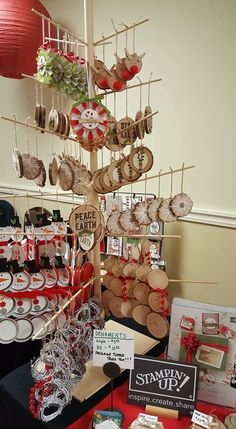 a table with many items on it and some tags hanging from the ceiling above them