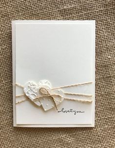 a close up of a greeting card with a heart on the front and ribbon at the bottom