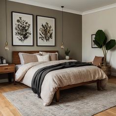 a bedroom with two framed pictures above the bed