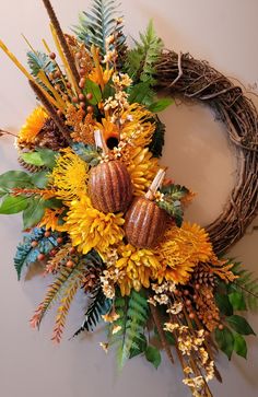 a fall wreath with sunflowers and pumpkins