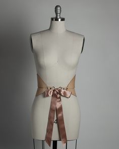 Wide curved and structured waist belt with satin ribbon ties. Style has been updated to be stitched along the waistband. Available in leather, vegan leather, or pvc. Silver-toned nickel plated steel hardware. Ribbon is premium double-faced satin ribbon imported from Japan. Shown in natural tan leather. Ribbon is matches material color (clear has black ribbon). Custom sizing available. All pieces are MADE TO ORDER, standard sizes XS-4XL. If your measurements fall outside these standards or you ar Burlesque Feathers, Pvc Corset, Dark Sunset, Horween Chromexcel, Belt Wide, Forest Witch, Clothing Reference, June Bug, Oxblood Leather