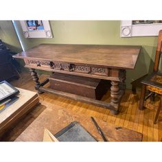 an old wooden table and chair in a room