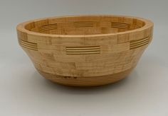 a wooden bowl sitting on top of a table