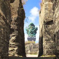 an image of a statue in the middle of some stone walls that look like they have been carved into them